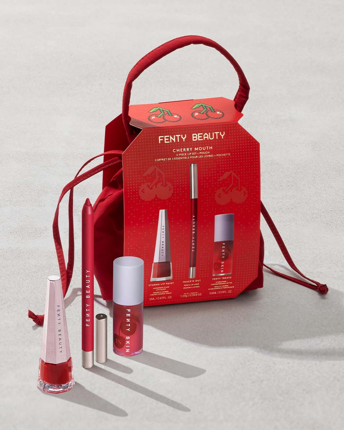 Cherry Mouth 3-Piece Lip Set includes Stunna Lip Paint, Traced Out Lip Pencil Liner, and Fenty Treats Lip Oil with an exclusive cherry red Fenty Beauty pouch.