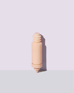 Container of the refill for the Watch Ya Tone Niacinamide Serum on a lilac background.